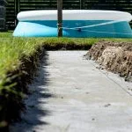 Foundation footings poured in a ditch in the yard, building a terrace in the backyard.