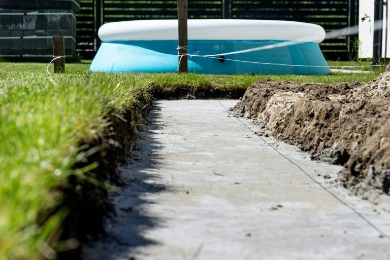 Foundation footings poured in a ditch in the yard, building a terrace in the backyard.