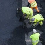 Workers during Asphalting Road Work on city street