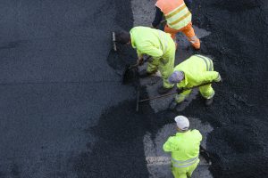 Workers during Asphalting Road Work on city street