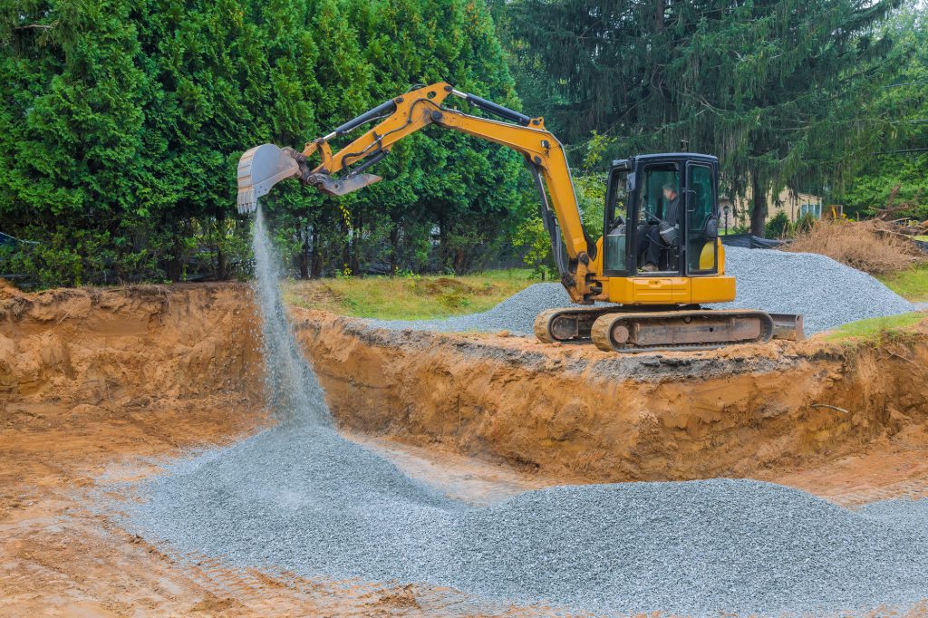 To serve as a foundation for a concrete structure, excavators fill irregularities in excavations